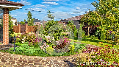 Landscape design at residential house. Beautiful landscaping in home garden Editorial Stock Photo