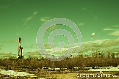 Landscape with a drilling rig at an oil field. Sunny day, early spring. Industrial landscape. Russia, Western Siberia. Stock Photo