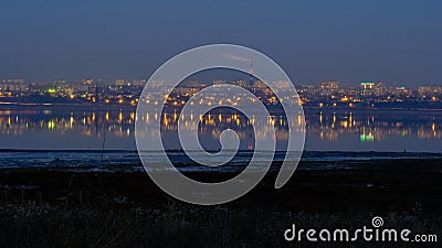 The landscape with the evening lights of the village of Kotovsky, which reflects the Kuyanik in the rhizome. Odessa Stock Photo