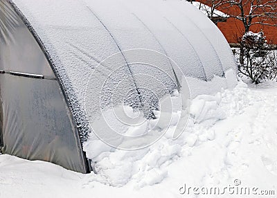 landscape with a film greenhouse snow on the greenhouse winter Stock Photo