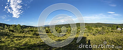 Landscape in the french Jura region with green meadows and blue Stock Photo