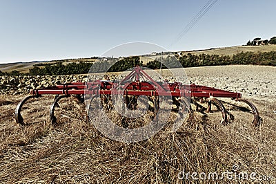 Harrow on the plowed field Stock Photo
