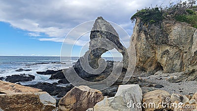 Landscape of the Horse Head Rock under a blue cloudy sky in Wallaga Lake, Australia Stock Photo
