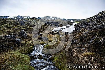 Landscape Iceland green grass snow Waterfall Stock Photo