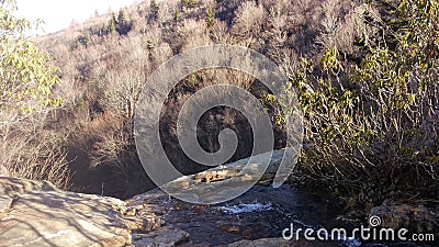 Landscape image of a drop off with a waterfall running off the edge Stock Photo