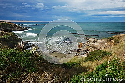 Landscape image of an oceanic beach with moody sky Stock Photo