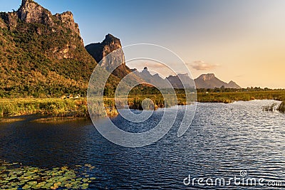 Landscape of Lotus Flowers Lake and Mountain Scenery at Sunset, Natural Countryside Background Stock Photo