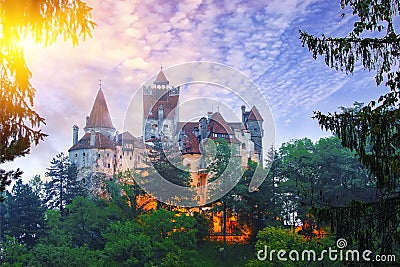 Landscape with medieval Bran castle known for the myth of Dracula at sunset Stock Photo