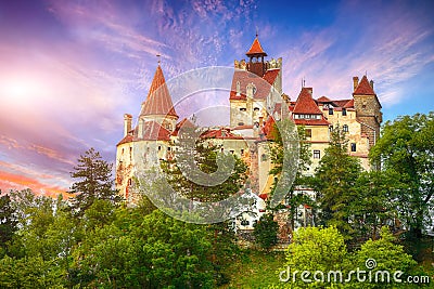 Landscape with medieval Bran castle known for the myth of Dracula at sunset Stock Photo