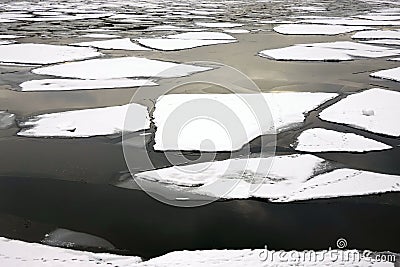 Landscape with melting broken ice floes floating on the river Stock Photo