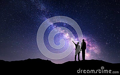 Landscape with Milky Way. Silhouette of a father and son Stock Photo