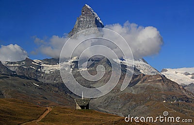 A landscape with a mountain Matterhorn view partially covered by clouds on a mountain Gornergrat, Switzerland Stock Photo