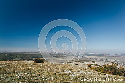 Distant hills. Hilly steppe. Curvy hills. Blue sky and grass. Beautiful plain. Sunny day and hills Stock Photo