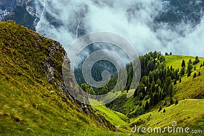 landscape with mountains, hills, rocks, trees and fog Stock Photo