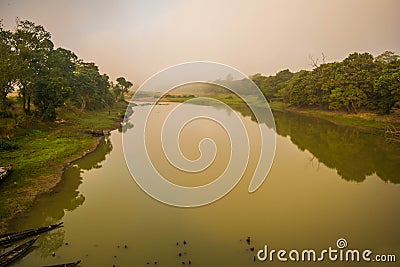 Landscape of mountains, tree and fog in the Sunrise time at Kaziranga national park, Assam, India. Stock Photo