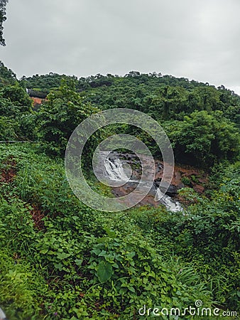 A landscape phot of a sawatsada waterfall in the middle of a forest in chiplun. Stock Photo