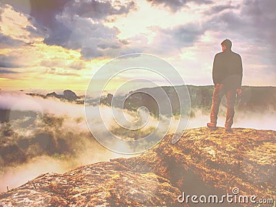 Landscape photograper with camera ready in hand. Man climbed up Stock Photo