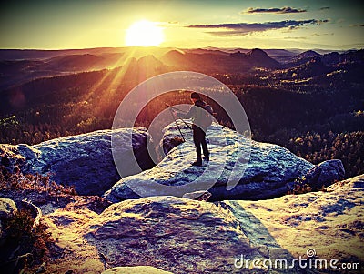 Landscape Photographer climbed on peak for photographing the sunrise Stock Photo