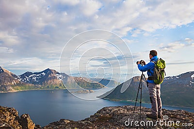 Landscape photographer working with tripod and dslr camera Stock Photo