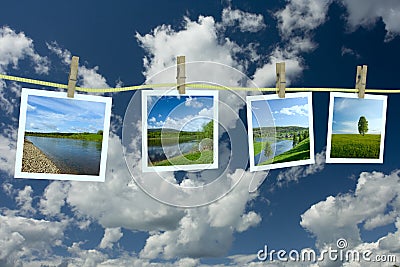 Landscape photographs hanging on a clothesline Stock Photo