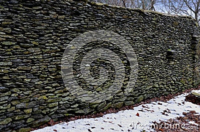 a landscape plagued by frost and snow with walls of flat stones Stock Photo