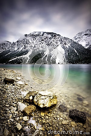 Plansee lake and Alps mountains during winter, snowy view, Tyrol, Austria. Stock Photo