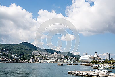 Landscape of port with a large cruise ship in Nagasaki, Kyushu, Japan. Editorial Stock Photo