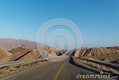 Landscape with range of stunning mountains in the background with a blue sky overhead Stock Photo