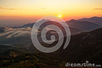 Landscape from Rhodope mountains in Bulgaria during sunset or sunrise. Small chapel and monastery near Borovo Stock Photo