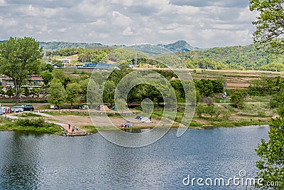 Landscape of river and camping site under cloudy sky Editorial Stock Photo