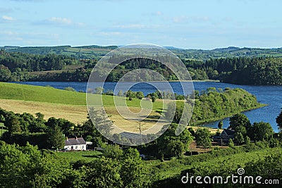 Cottage home nestled amongst fields of farmland pastures Stock Photo