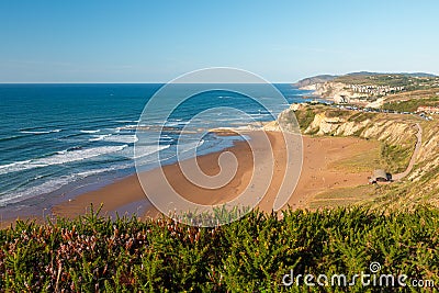 Landscape of sandy beach Sopelana near Bilbao, Basque country, Spain. Coastline with cliffs in Euskadi near Bilbo Stock Photo