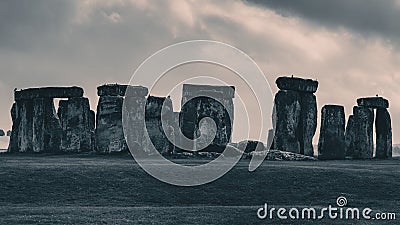 Landscape scene of Stonehenge monument in England under dramatic cloudy sky Stock Photo