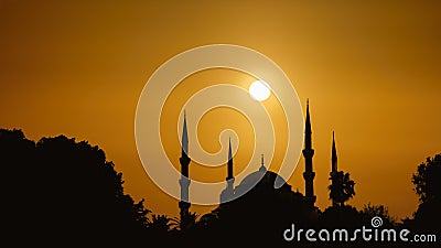 Silhouette islamic mosque with dome and two tower with background of sunrising Stock Photo