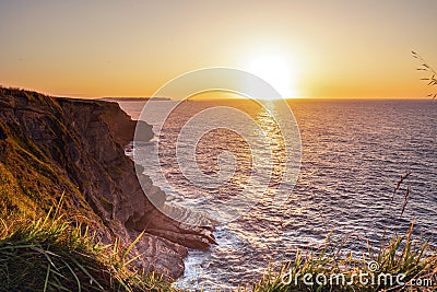 Landscape of sea with montains, dramatic wave and rock in sunset Stock Photo