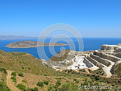 Landscape and seascape of Crete with view of gypsum quarry Stock Photo