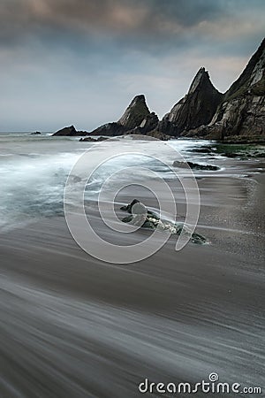 Landscape seascape of jagged and rugged rocks on coastline with Stock Photo