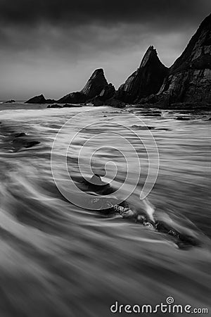 Landscape seascape of jagged and rugged rocks on coastline with Stock Photo