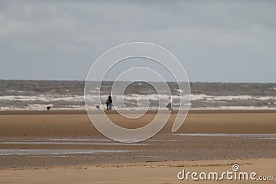 A landscape shot at Formby Beach, dog walkers can be seen in the background Stock Photo