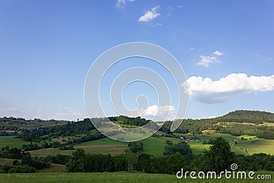landscape springtime green fields with blue sky and clouds Stock Photo