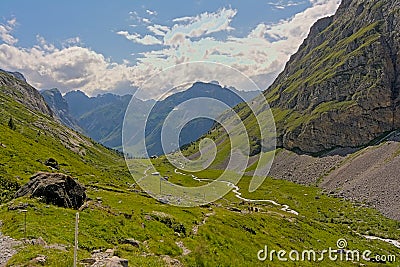 Cloudy mountains and valley with little river in the French Alps Stock Photo