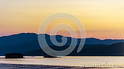 Landscape sunset with Reservoir and raft house Thailand Stock Photo