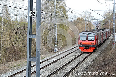 Landscape with a two-way railway with rails, with a train. with electricity poles. Stock Photo