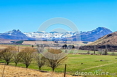 Landscape of Underberg , a small countryside village with snow clad drakensberg mountains and green landscapes Stock Photo