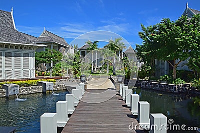 Landscape View of Beautiful upscale resort hotel with small wooden bridge connecting the walkway with the villas Stock Photo