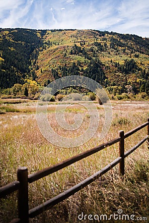 Landscape view of fence with mountains and fall foliage near Aspen, Colorado. Stock Photo