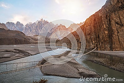 Landscape view of Hussaini hanging bridge above Hunza river, surrounded by mountains. Pakistan. Stock Photo