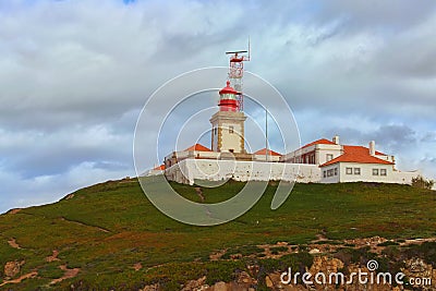 Landscape view of lighthouse on the hill at the Cabo da Roca. It is a cape which forms the westernmost extent of mainland Portugal Stock Photo