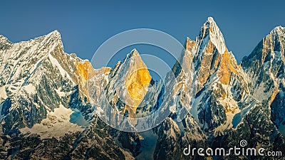 Landscape view of mountain range and peaks lit by golden sunlight, Himalayas, Nepal Stock Photo