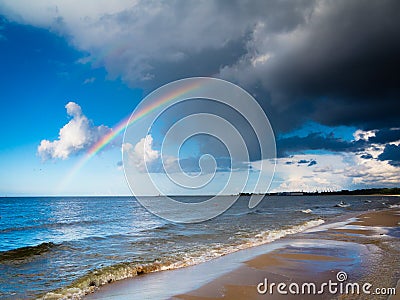 Landscape view on sky with rainbow at sea. Stock Photo